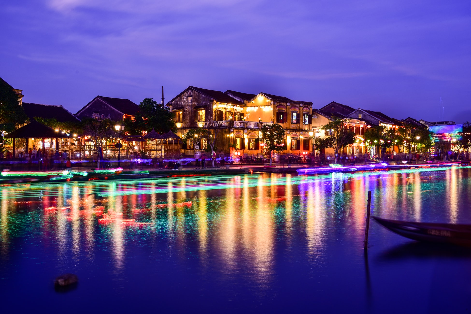 rows of lit houses along river